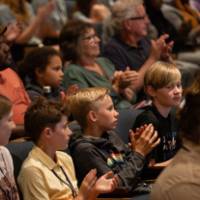 students clapping in audience